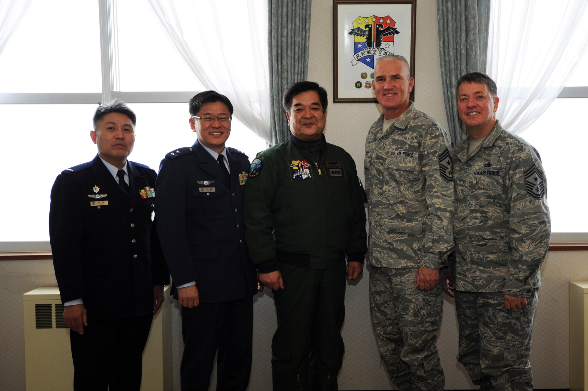 MISAWA AIR BASE, Japan -- From left, Warrant Officer Akihiko Ito, Northern Air Defense Force command chief master sergeant, Maj. Gen. Nobuyoshi Kojima, NADF vice commander, Lt. Gen. Osamu Shigehisa, NADF commander, Chief Master Sgt. Brooke McLean, Pacific Air Forces command chief, and Chief Master Sgt. Russell Hastings, 35th Fighter Wing command chief, pose for a photograph after a meeting, here Jan. 26. The meeting consisted of discussions on the importance of maintaining a good relationship between Japanese and American Forces. (U.S. Air Force photo/Airman 1st Class Kia Atkins)