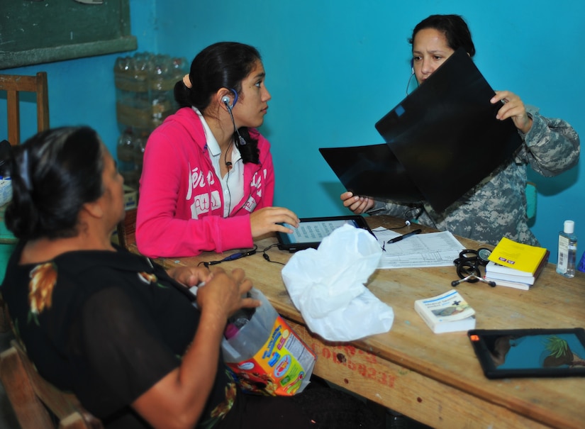 OLANCHO, Honduras – Captain Amanda Carnes, a 1st Battalion, 228th Aviation Regiment flight doctor, and Kimberly Hernandez, a translator, utilize a mobile-translation device during a Joint Medical Readiness Training Exercise Jan. 30 to the region. The Medical Application of Speech Translation team from Southern Command traveled with the Joint MEDRETE to test their products and to create a large database of medical terms and phrases which will enhance their translation software in order to improve interaction between medical providers and patients during humanitarian and disaster relief operations. (Air Force photo/Staff Sgt. Bryan Franks)  