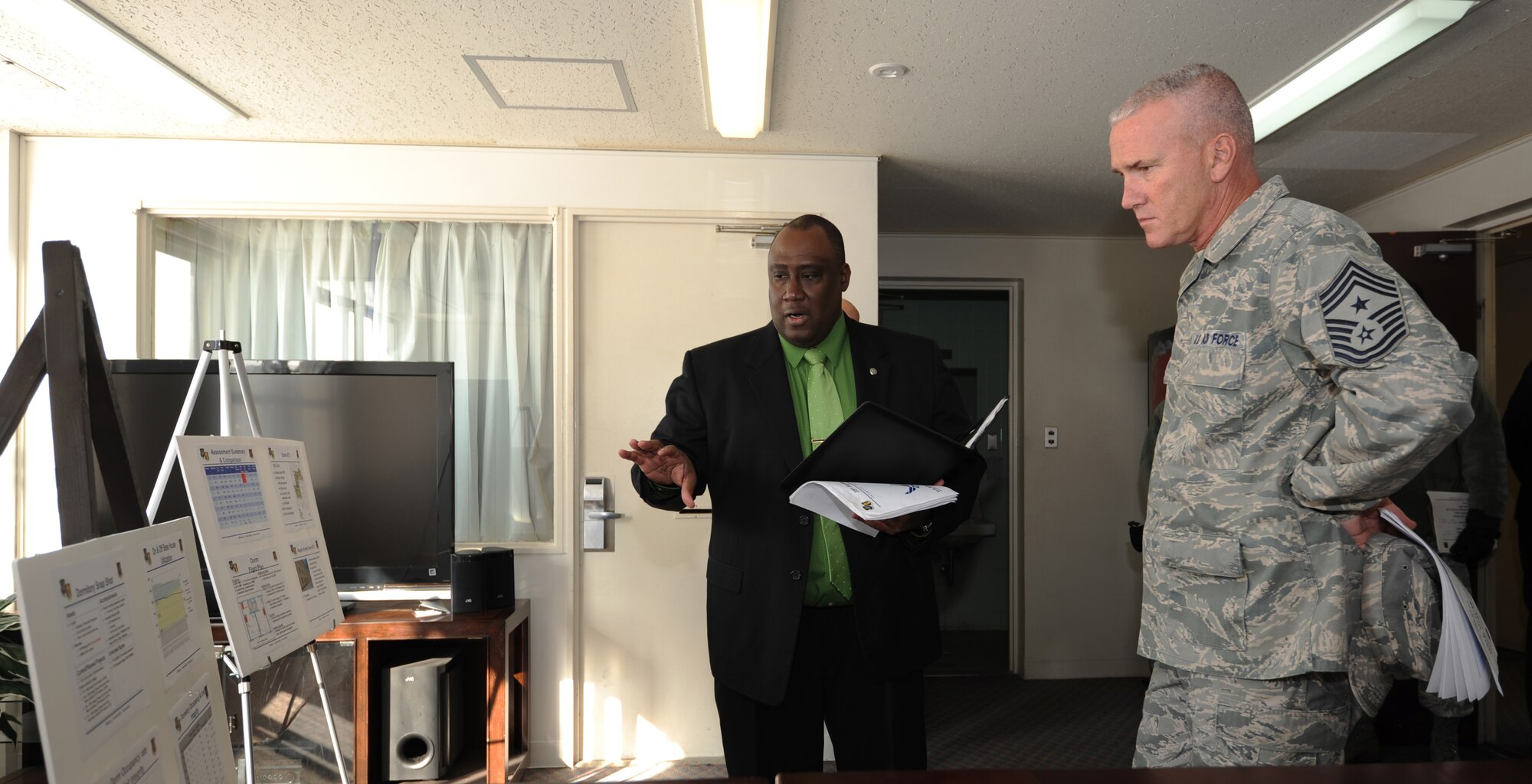 MISAWA AIR BASE, Japan -- Avery Borders, 35th Civil Engineer Squadron chief of capital asset management, and Chief Master Sgt. Brooke McLean, Pacific Air Forces command chief, discuss plans for repairing Dormitory 673, here Jan. 25. Dormitory 673, built in 1981, is the oldest dormitory on base and has never been renovated. (U.S. Air Force photo/Airman 1st Class Kia Atkins)