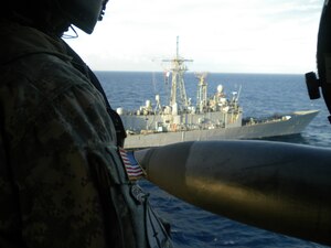 GUANAJA ISLAND, Honduras - A soldier observes the USS Nicholas as the UH-60 Blackhawk pilots, 1st Battalion, 228th Aviation Regiment, Soto Cano Air Base, Honduras, make their final pass here Jan. 25. Eight JTF-Bravo pilots completed five consecutive bounces, which are landings, liftoffs, circling then repeating the process. It takes approximately 30 minutes for each pilot to complete the deck-landing qualification. In total, 11 crew members qualified and now the battalion has four-qualified crews. This training increases the unit's ability to provide humanitarian assistance and disaster relief as well as enhances its' medical evacuation capability. (U.S. Army photo/Capt. David Zupancic)