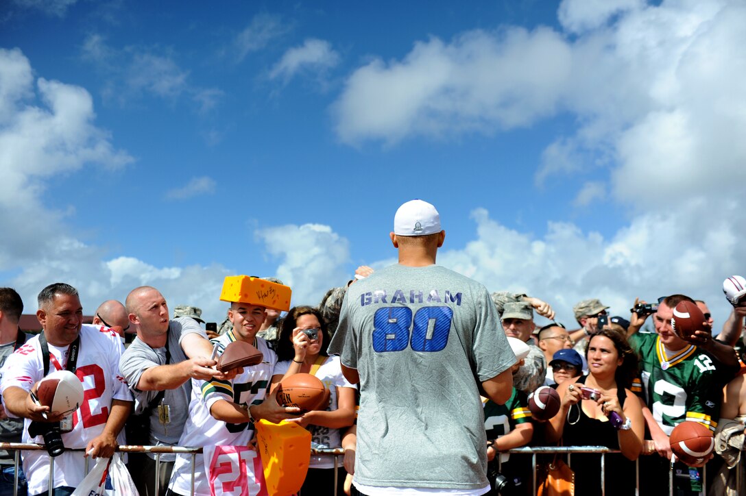 Jimmy Graham, a New Orleans Saints tight end, signs autographs for service members and their families during the Pro Bowl practice at Earhart Field on Joint Base Pearl Harbor-Hickam, Hawaii, Jan. 26, 2012. Graham is a two-year veteran of the league with 1,666 yards receiving and 16 touchdowns. (U.S. Air Force photo/Staff Sgt. Mike Meares)