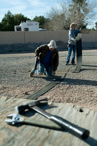 Rob Taylor and Loren Wike, 99th Force Support Squadron laborers, mark spaces in a new vehicle storage area Jan. 30, 2012, at Nellis Air Force Base, Nev. The Nellis Outdoor Recreation Center will control this property, which is scheduled to open by Feb. 3, 2012. (U.S. Air Force photo by Staff Sgt. Christopher Hubenthal) 