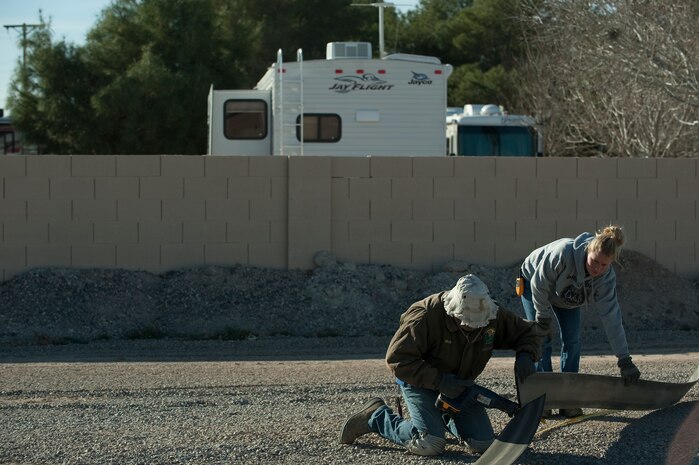 Rob Taylor and Loren Wike, 99th Force Support Squadron laborers, mark spaces in a new vehicle storage area Jan. 30, 2012, at Nellis Air Force Base, Nev. The Nellis Outdoor Recreation Center will control this property, which is scheduled to open by Feb. 3, 2012. (U.S. Air Force photo by Staff Sgt. Christopher Hubenthal)