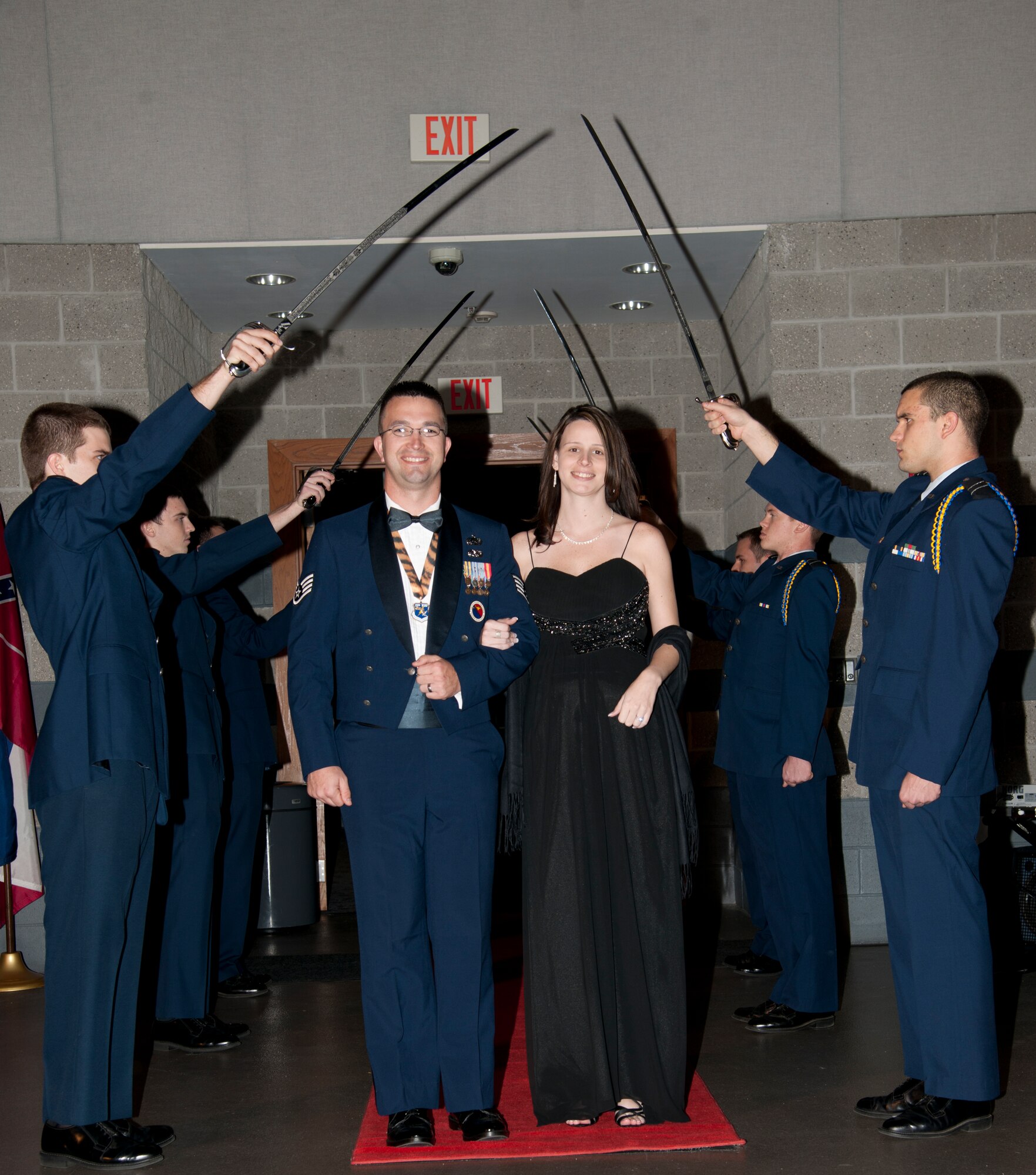 Cadets from the Valdosta State University Air Force ROTC Detachment 172 conduct a saber detail as U.S. Air Force Staff Sgt. Michael Youngblood, 2011 Noncommissioned Officer of the Year nominee, and his wife, Christina, enter the Annual Awards Banquet at the James H. Rainwater Conference Center in Valdosta, Ga., Jan. 28, 2012.  It is customary for nominees to enter through the sabers and be introduced along with accomplishments before proceeding to their seats. (U.S. Air Force Photo by Airmen 1st Class Paul Francis/Released)
