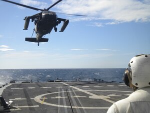 GUANAJA ISLAND, Honduras - A UH-60 Blackhawk crew, 1st Battalion, 228th Aviation Regiment, Soto Cano Air Base, Honduras, conducts deck-landing qualification training aboard the USS Nicholas here Jan. 25. Eight JTF-Bravo pilots completed five consecutive bounces, which are landings, liftoffs, circling then repeating the process. It takes approximately 30 minutes for each pilot to complete the deck-landing qualification. In total, 11 crew members qualified and now the battalion has four-qualified crews which is a semi-annual requirement. This training increases the unit's ability to provide humanitarian assistance and disaster relief as well as enhances its' medical evacuation capability. (U.S. Army photo/Capt. David Zupancic) 