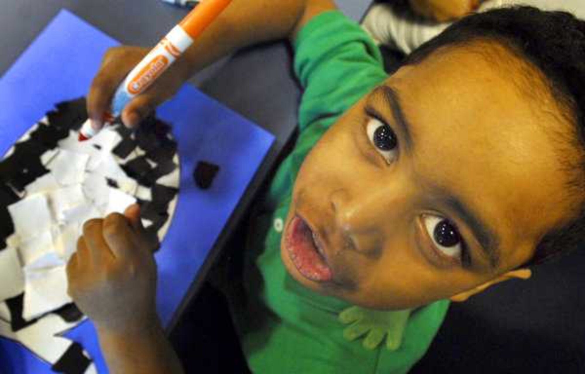 Horacio Bowen, 4, displays his paper mosaic penquin at the McChord Library Jan. 12 at Joint Base Lewis-McChord, Wash. (U.S. Air Force courtesy photo/Scott Hansen)