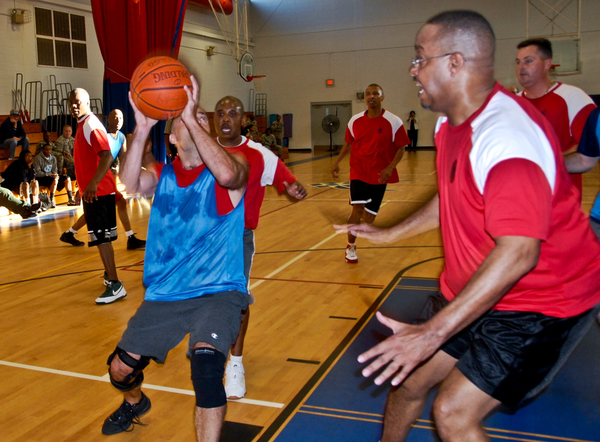 Sal Nodjomian is swarmed by Chiefs basketball players as he looks to score at the annual Eagles versus Chiefs basketball game Jan. 27.  The Eagles won for the second straight year, 50-40. (U.S. Air Force photo/Kevin Gaddie)