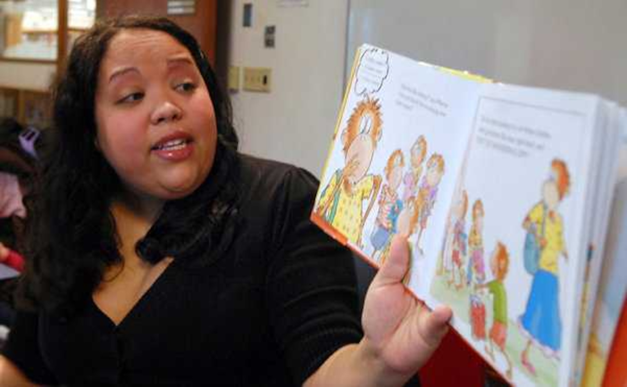 Storyteller Rachael Sweeney reads from the children's book ''Five Little Monkeys Go Shopping'' during Storytime at the McChord Library Jan. 12 at Joint Base Lewis-McChord, Wash. (U.S. Air Force courtesy photo/Scott Hansen)