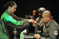 Lt. Shannon Scannon, 359th Aerospace Medicine Squadron OIC of academics and training, teaches Staff Sgt. Nazareth Oliver, 18th Aerospace Medicine Squadron, how to attach night vision goggles to his helmet during a NVG Academic Instructors Course held at the Aerospace Physiology building on Joint Base San Antonio-Randolph Jan. 25. (U.S. Air Force photo/Rich McFadden) (released)