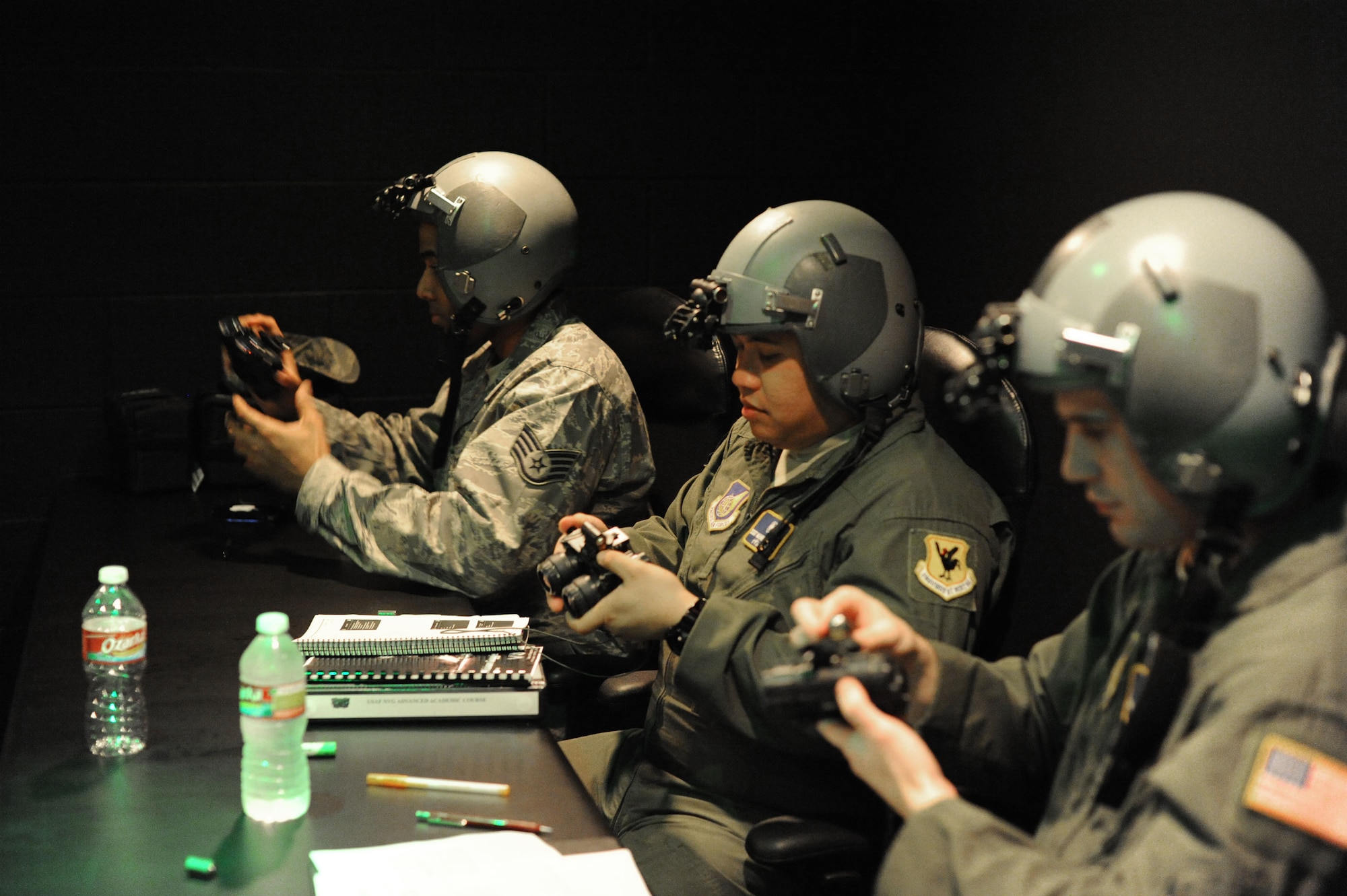 (From left) Staff Sgt. Sadek Brandford, 27th Special Operations Support Squadron aerospace physiology technician, Staff Sgt. Nazareth Oliver, 18th Aerospace Medicine Squadron and Senior Airman Clint Copeland, 18th Aerospace Medicine Squadron, learn to attach night vision goggles to their helmet during a NVG Academic Instructors Course held at the Aerospace Physiology building on Joint Base San Antonio-Randolph Jan. 25. (U.S. Air Force photo/Rich McFadden) (released)