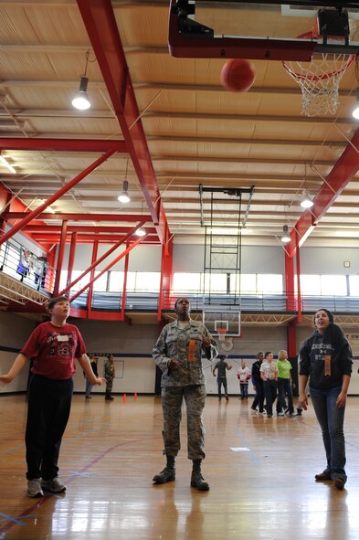 Senior Master Sgt. Lasauna Nolan-Tucker and Ana Krussell wait in anticipation for Willy Vanduyne’s, 11, basketball to fall through the net during the Wayne County Special Olympics basketball games in Goldsboro, N.C., Jan. 25, 2012. Before the start of an event the participants recite the Special Olympic athlete’s oath, “Let me win. But if I cannot win, let me be brave in the attempt.” Nolan-Tucker, 916th Force Support Squadron Airman and family services chief, is from Galveston, Texas. Krussell, spouse of Airman 1st Class Alex Krussell, a 4th Civil Engineer Squadron structural journeyman hails from Woodstock, Ga. Vanduyne attends Greenwood Middle School. (U.S. Air Force photo/ Staff Sgt. Courtney Richardson)