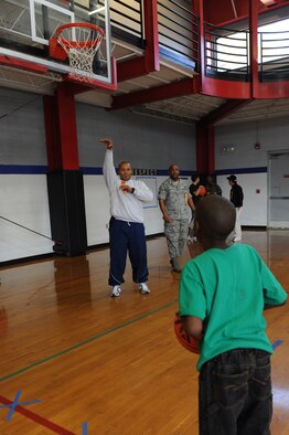 Senior Airman John-Michael Cobb watches for Yvonne Jackson, 10, basketball to fall through the net during the Wayne County Special Olympics basketball games in Goldsboro, N.C., Jan. 25, 2012. The Special Olympics is the world's largest sports organization for children and adults with intellectual disabilities. More than 3.7 million athletes in more than 170 countries compete in Special Olympics. Cobb, 334th Aircraft Maintenance Squadron crew chief, hails from Greenville, S.C. Jackson attends Tommy’s Road Elementary School. (U.S. Air Force photo/Staff Sgt. Courtney Richardson) 