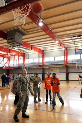 Senior Airman John-Michael Cobb watches for Yvonne Jackson's, 10, basketball to fall through the net during the Wayne County Special Olympics basketball games in Goldsboro, N.C., Jan. 25, 2012. The Special Olympics is the world's largest sports organization for children and adults with intellectual disabilities. More than 3.7 million athletes in more than 170 countries compete in Special Olympics. Cobb, 334th Aircraft Maintenance Squadron crew chief, hails from Greenville, S.C. Jackson attends Tommy’s Road Elementary School. (U.S. Air Force photo/Staff Sgt. Courtney Richardson) 