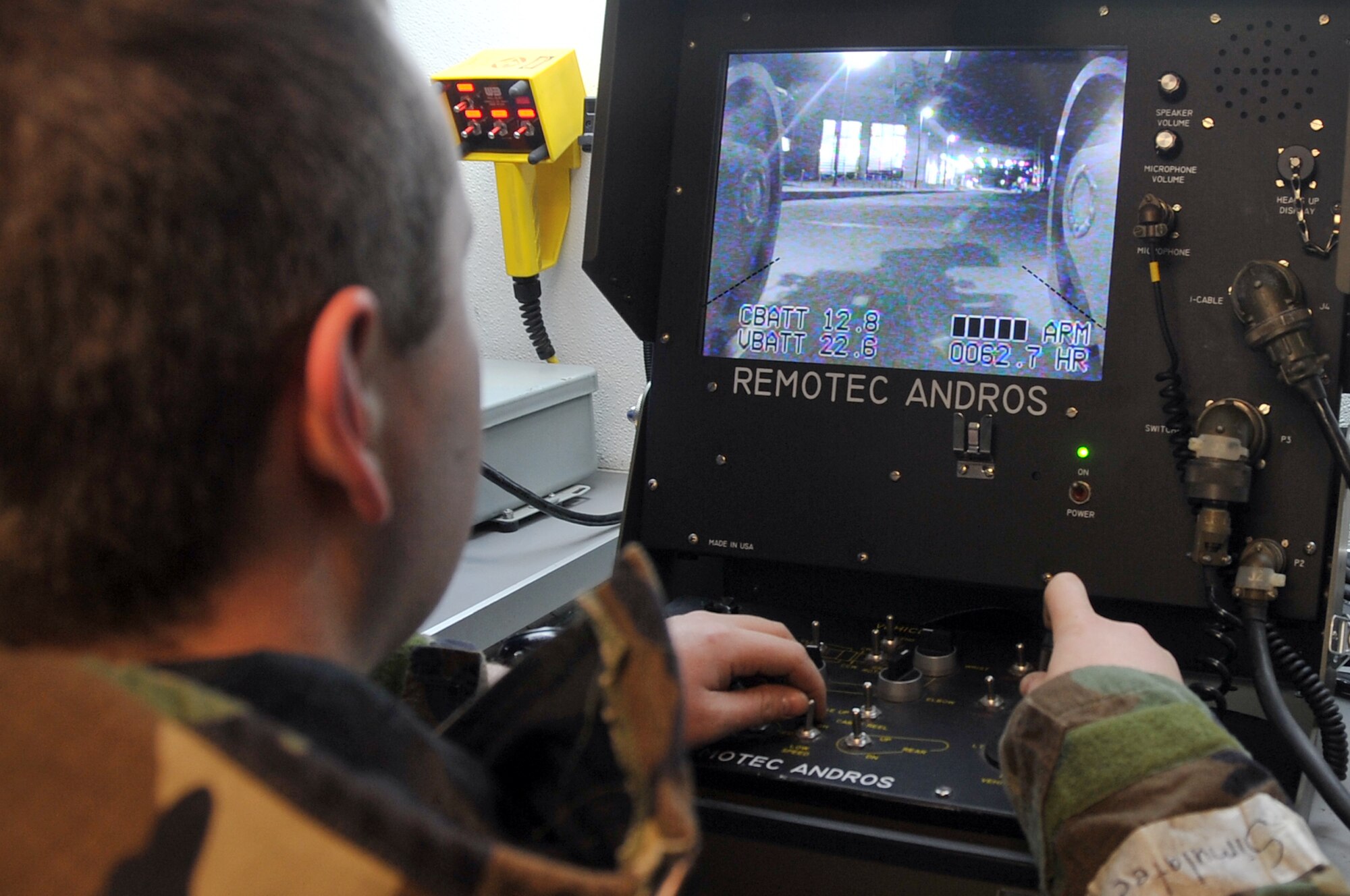 Senior Airman Matthew Workoff, 51st Civil Engineer Squadron, uses a remote control interface to operate the ANDROS F6 robot, Jan. 30, 2012. The Airmen are participating in a peninsula-wide operational readiness exercise, Beverly Bulldog 12-01, held to train U.S. forces throughout South Korea. (U.S. Air Force photo/Staff Sgt. Craig R. Cisek)