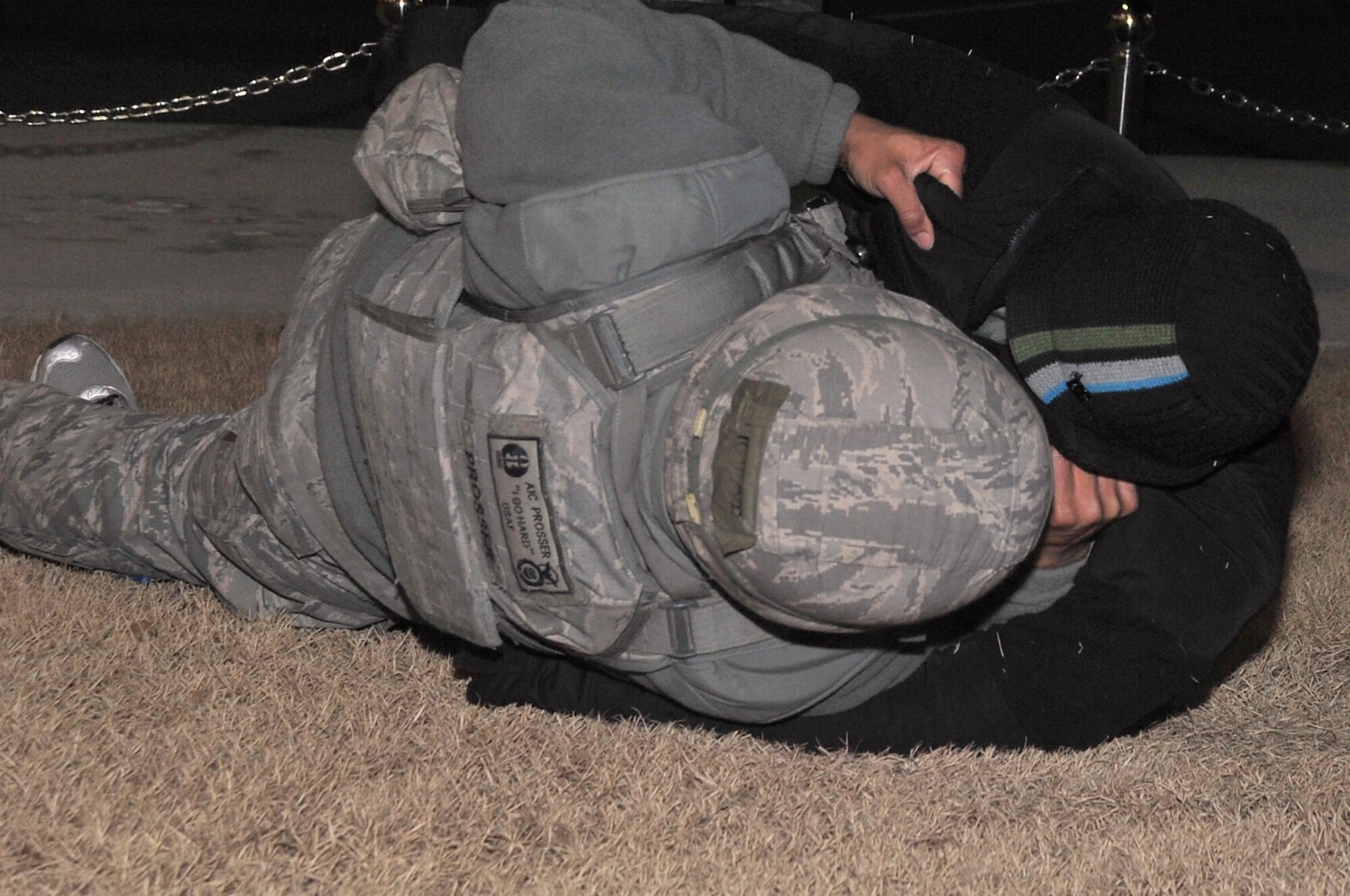 Airman 1st Class Brandon Prosser, 51st Security Forces Squadron, performs a dead body search, which revealed wires protruding from the active shooter’s clothes, Jan. 30, 2012. The Airmen are participating in a peninsula-wide operational readiness exercise, Beverly Bulldog 12-01, held to train U.S. forces throughout South Korea. (U.S. Air Force photo/Staff Sgt. Craig R. Cisek)