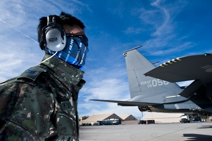 A Republic of Korea Air Force Airman watches an F-15E Strike Eagle taxi to the runway during Red Flag 12-2 Jan. 27, 2012, at Nellis Air Force Base, Nev. Red Flag is a realistic combat training exercise involving the air forces of the United States and its allies. The exercise is hosted north of Las Vegas on the Nevada Test and Training Range. (U.S. Air Force photo by Airman 1st Class Daniel Hughes)