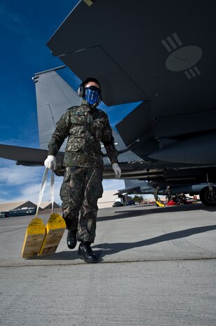 A Republic of Korea Air Force Airman pulls chalks from an F-15E Strike Eagle during Red Flag 12-2 Jan. 27, 2012, at Nellis Air Force Base, Nev. Red Flag is a realistic combat training exercise involving the air forces of the United States and its allies. The exercise is hosted north of Las Vegas on the Nevada Test and Training Range. (U.S. Air Force photo by Airman 1st Class Daniel Hughes)