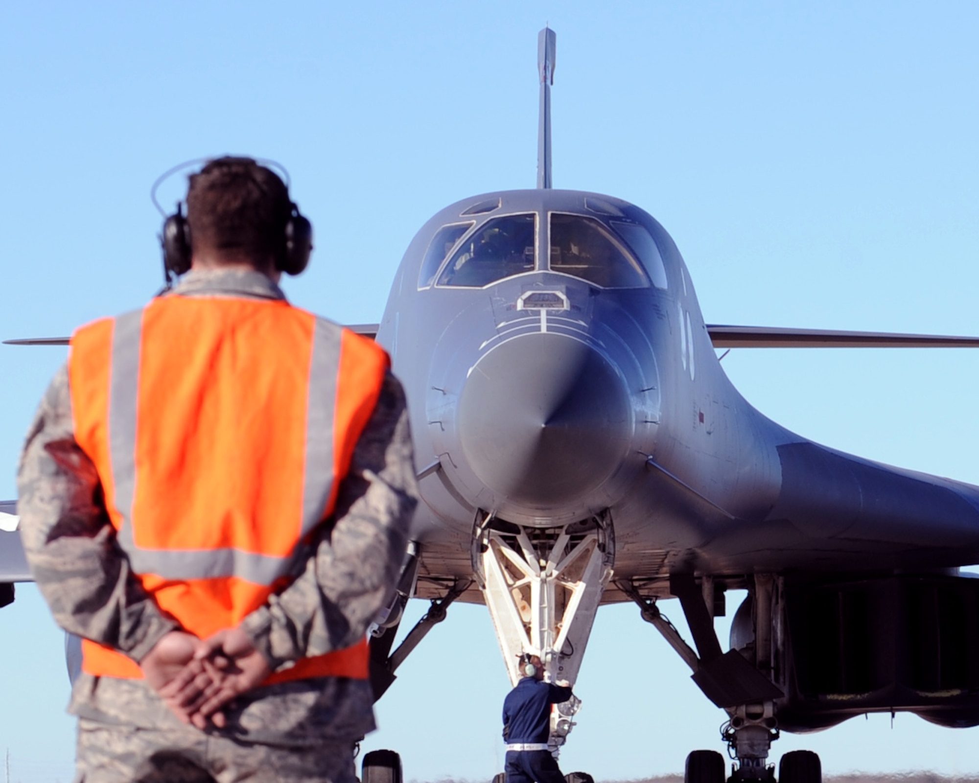 A U.S. Air Force crew chief marshals out a B-1 Bomber carrying a BLU-129, Jan. 20, 2012, at Dyess Air Force Base, Texas. The BLU-129 is a 500-pound guided bomb designed with a composite warhead to destroy targets while causing the lease amount of collateral damage. (U.S. Air Force photo by Airman 1st Class Jonathan Stefanko/Released)