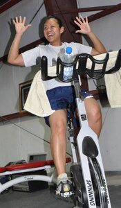 Staff Sgt. Sokum Ouk, 332nd Expeditionary Force Support Squadron fitness journeyman, instructs a spin class Jan. 20, 2012 at an undisclosed location in Southwest Asia. Ouk said spin class is a fun way for Airmen to get in shape and meet new people. She is deployed from Langley Air Force Base, Va., and is a native of Chester, Va. (U.S. Air Force photo by Senior Airman Melanie Holochwost/Released)
