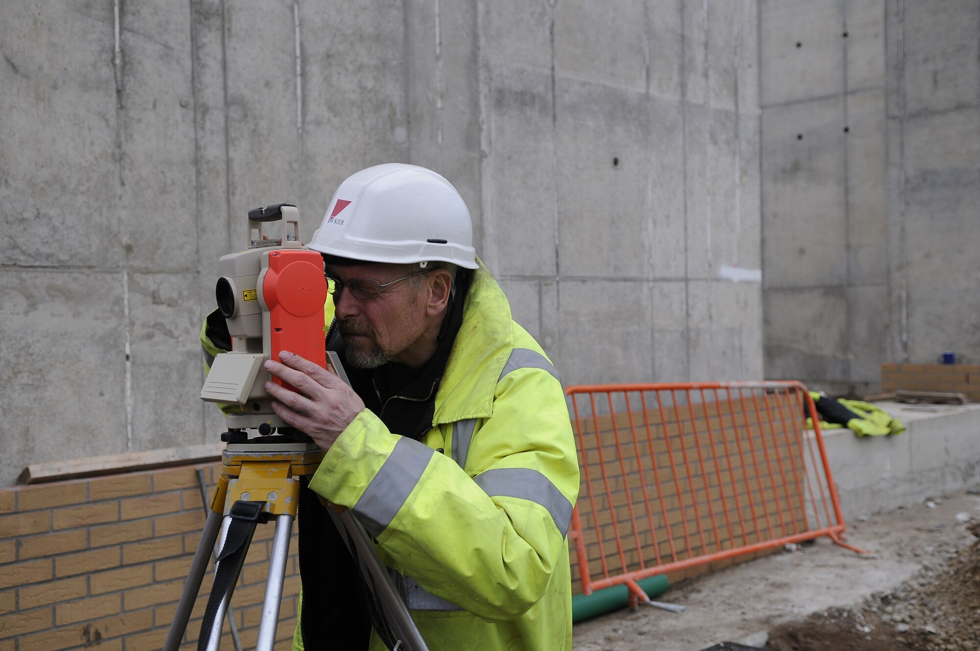 ROYAL AIR FORCE LAKENHEATH, England -- Tony Britt, Balfour Bealtty employee, takes a measurement using an electron distance machine at the new large vehicle inspection gate being constructed next to Brandon Road, Jan. 11, 2012.  The new gate will have the latest X-ray inspection technology and will help ease congestion around RAF Lakenheath's front gate.  It is estimated to be completed by August 2012.  (U.S. Air Force photo by Staff Sgt. Connor Estes)