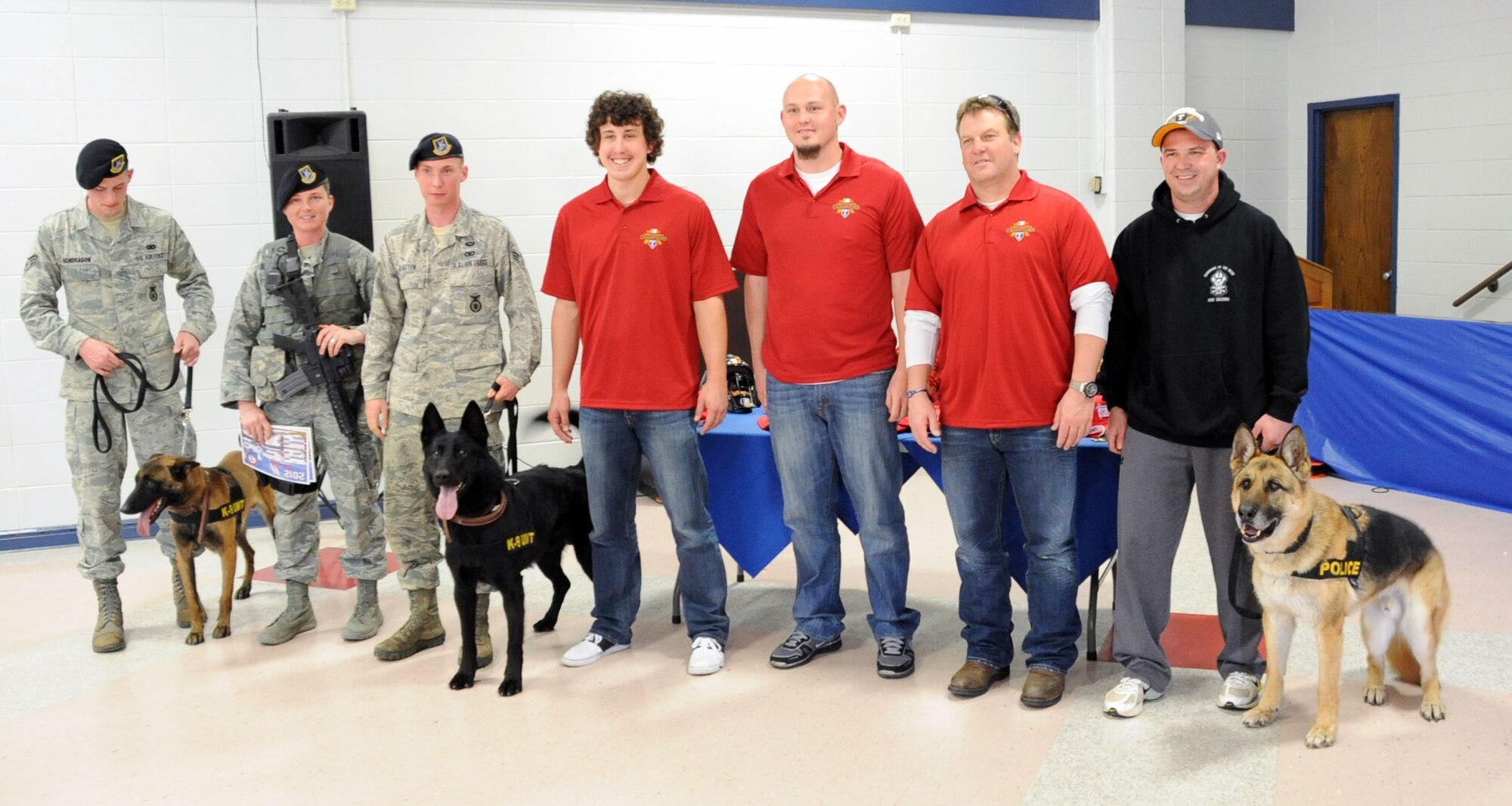 Members of Security Forces, along with their Military Working Dogs, pose for a photo along with members of the Texas Rangers.  The Texas Rangers Winter Caravan Tour made a stop at Sheppard Jan. 27 to allow fans the opportunity to get autographs and photos of the players. (U.S. Air Force Photo/ Josh Wilson)