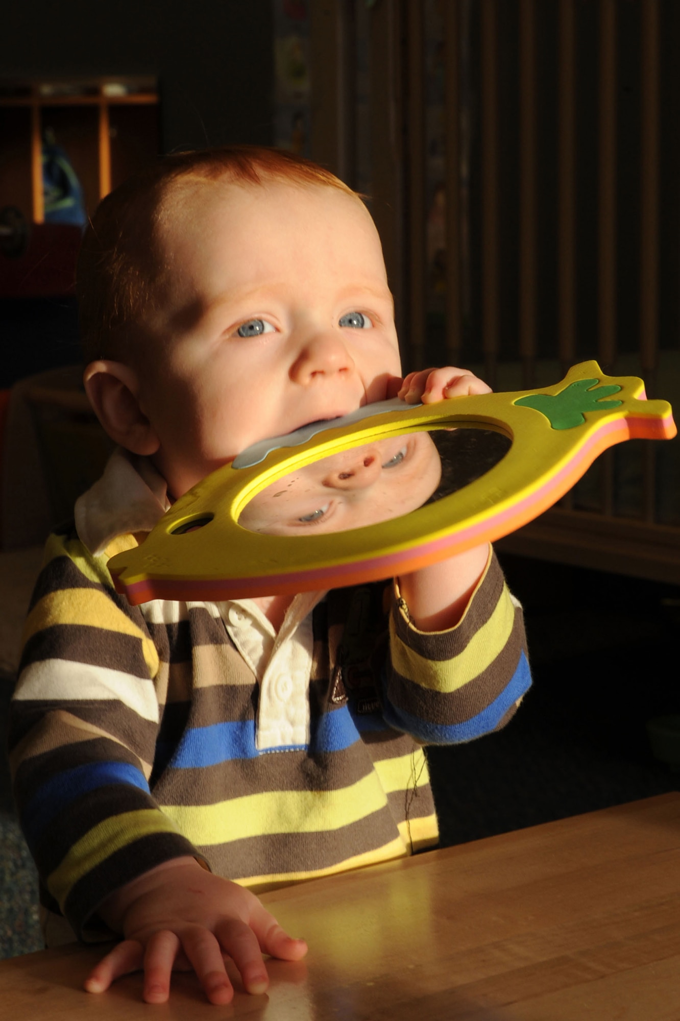 Tucker Banfield, son of U.S. Air Force Staff Sgt. Jeremy Banfield, 99th Logistics Readiness Squadron fuels service center craftsman, and his wife Shannon, plays as he looks out the window of the new Child Development Center II Jan. 27, 2012, on Nellis Air Force Base, Nev. The CDC II opened Jan. 23, 2012, and is dedicated to provide care for 64 infants. (U.S. Air Force photo by Staff Sgt. Taylor Worley)