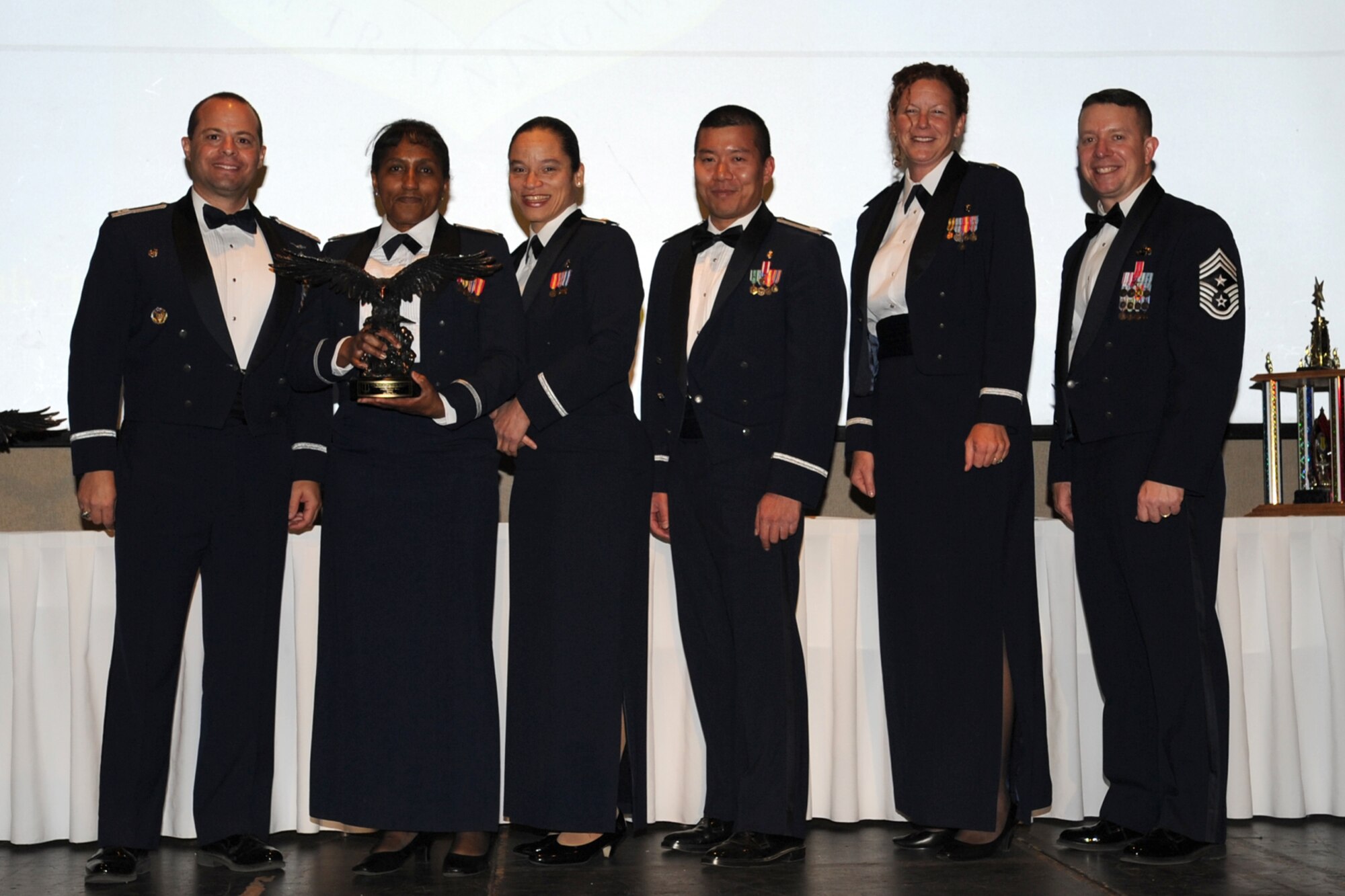 GOODFELLOW AIR FORCE BASE, Texas -- Leadership from the 17th Medical Operations Squadron accepts the 17th Training Wing 2011 Unit of the Year on behalf of the 17th MDOS from Col. Mark Damiano, 17th TRW Commander, and Chief Master Sgt. Brendan Criswell, 17th TRW Command Chief. The annual awards program recognizes military and civilian personnel who compete in 25 categories for their significant contributions to the 17th TRW, the community and the mission. (U.S. Air Force photo/Staff Sgt. Laura R. McFarlane) 