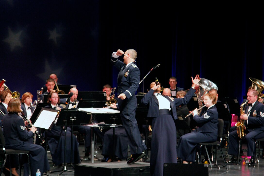 Major R. Michael Mench takes flight while conducting the Concert Band. (U.S. Air Force photo/TSgt Dan Bentley)