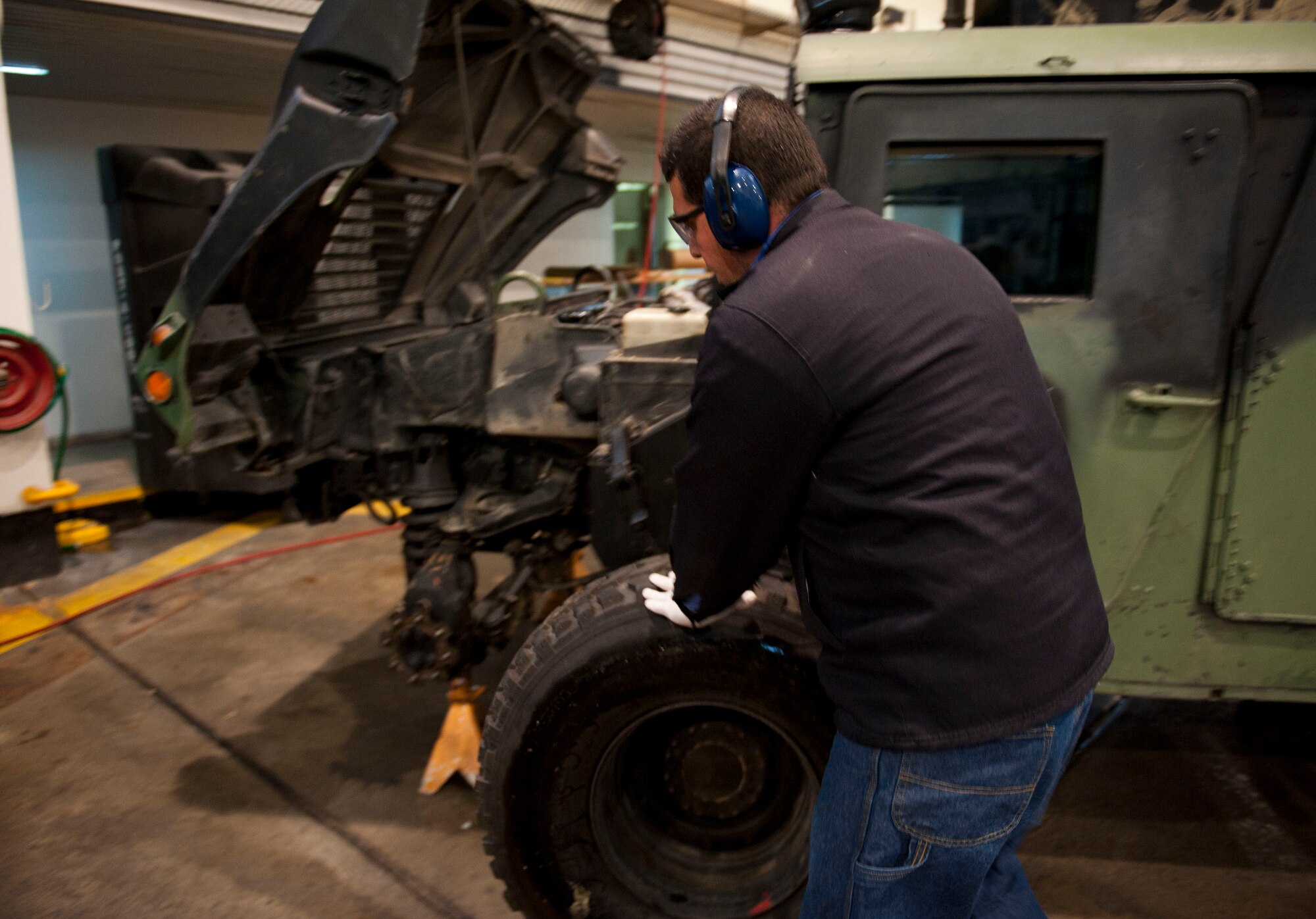 Aykut Kuralay, 39th Logistics Readiness Squadron, rolls a wheel to attach to a Humvee Jan. 26, 2012, at Incirlik Air Base, Turkey. Vehicle maintenance performs maintenance on all U.S. government motor vehicles and equipment assigned to Incirlik. They perform scheduled inspections and services, preventive maintenance and any repairs required to maintain the vehicle or equipment in a safe and serviceable condition. (U.S. Air Force photo by Senior Airman Clayton Lenhardt/Released)