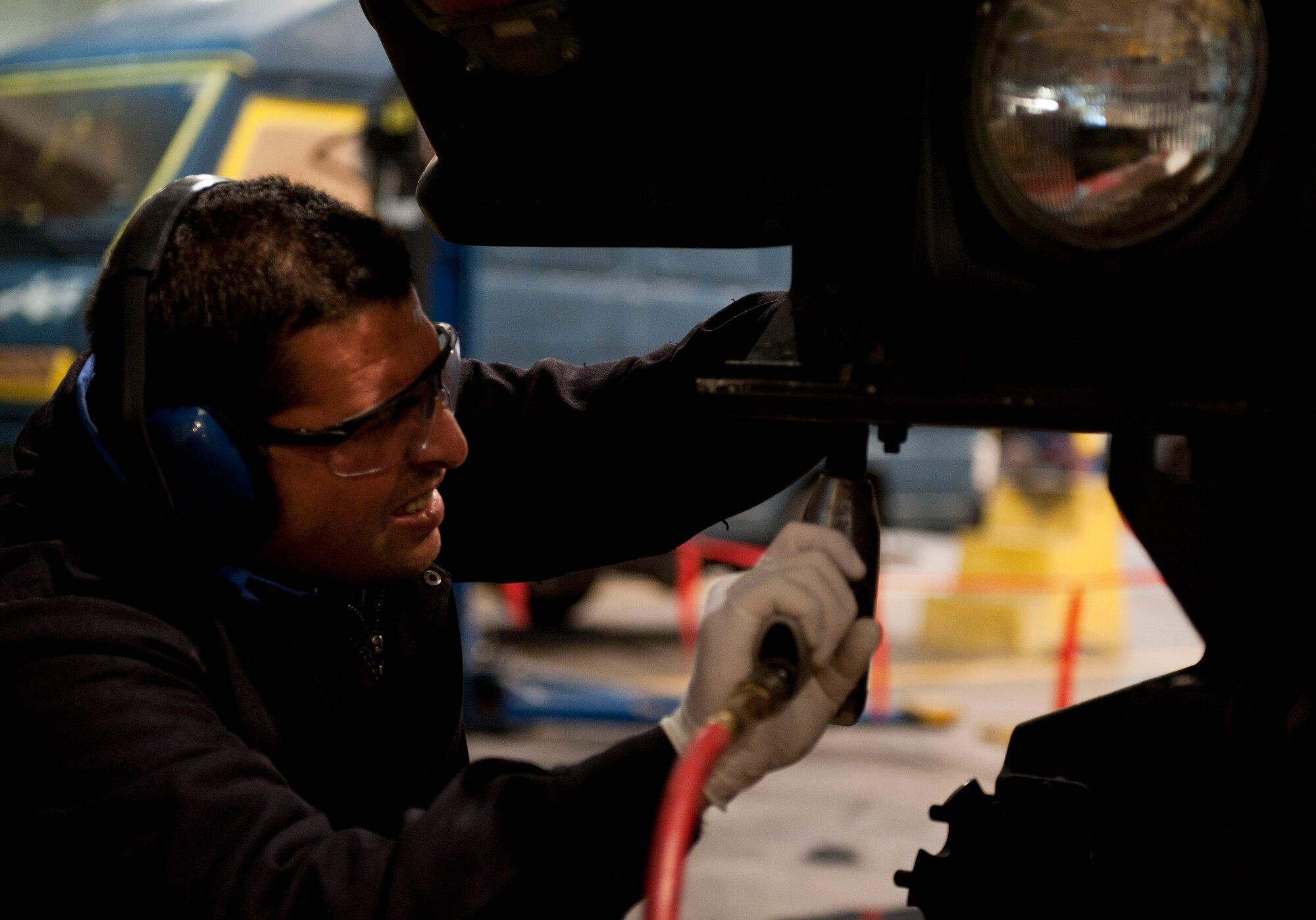 Aykut Kuralay, 39th Logistics Readiness Squadron, bolts a hood to a Humvee Jan. 26, 2012, at Incirlik Air Base, Turkey. Vehicle maintenance performs maintenance on all U.S. government motor vehicles and equipment assigned to Incirlik. They perform scheduled inspections and services, preventive maintenance and any repairs required to maintain the vehicle or equipment in a safe and serviceable condition. (U.S. Air Force photo by Senior Airman Clayton Lenhardt/Released)