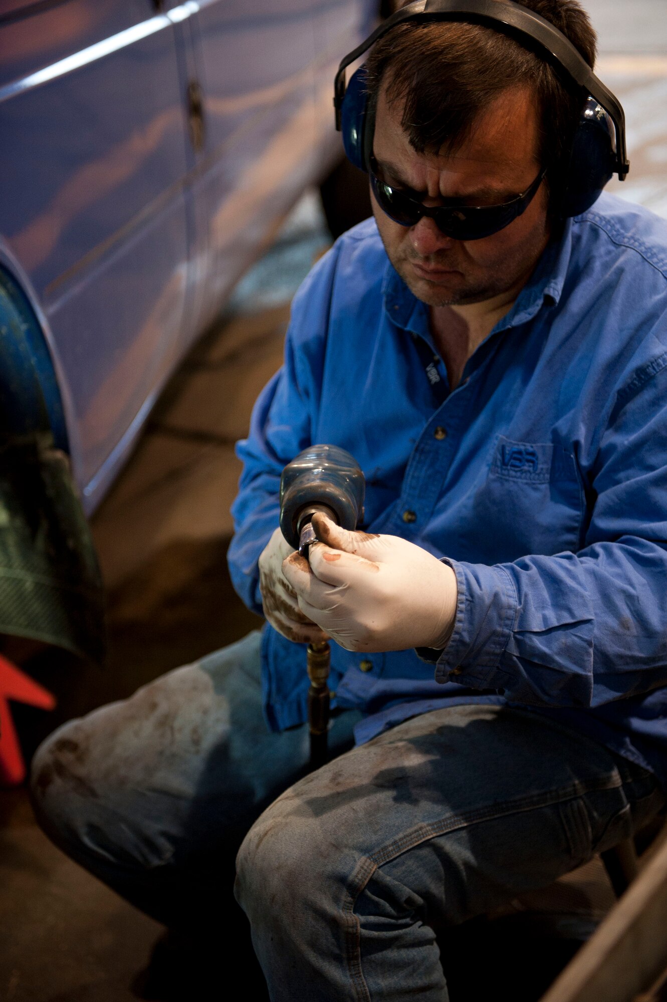 Ramazan Subasi, 39th Logistics Readiness Squadron, changes the head of a drill as he performs maintenance on a truck Jan. 26, 2012. Vehicle maintenance performs maintenance on all U.S. government motor vehicles and equipment assigned to Incirlik. They perform scheduled inspections and services, preventive maintenance and any repairs required to maintain the vehicle or equipment in a safe and serviceable condition. (U.S. Air Force photo by Senior Airman Clayton Lenhardt/Released)