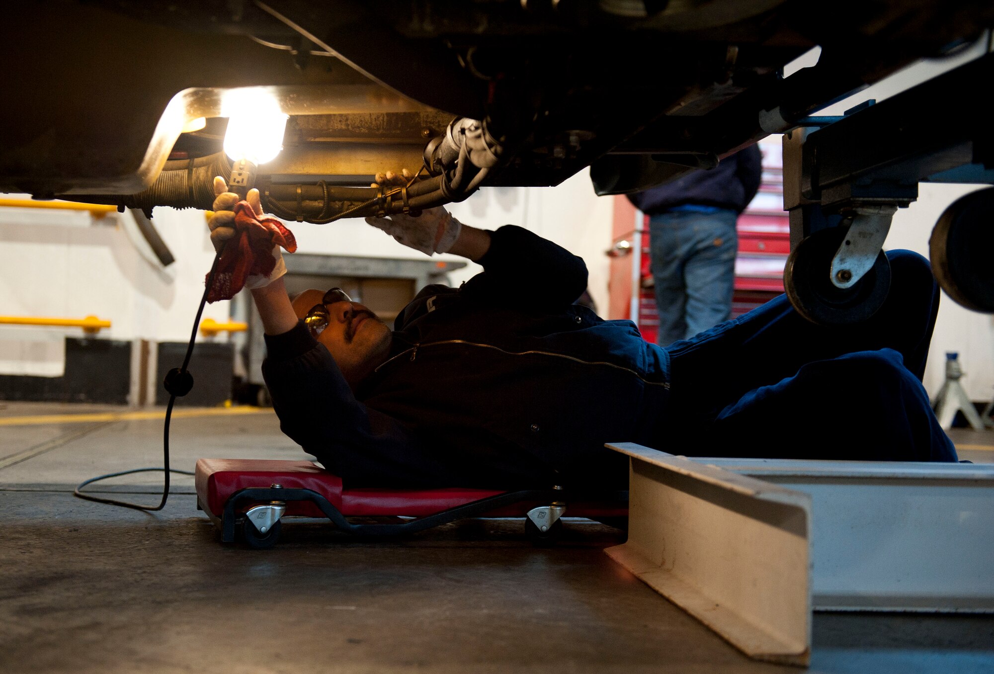 Omer Ugur, 39th Logistics Readiness Squadron, inspects underneath a bus Jan. 26, 2012, at Incirlik Air Base, Turkey. Vehicle maintenance performs maintenance on all U.S. government motor vehicles and equipment assigned to Incirlik. They perform scheduled inspections and services, preventive maintenance and any repairs required to maintain the vehicle or equipment in a safe and serviceable condition. (U.S. Air Force photo by Senior Airman Clayton Lenhardt/Released)