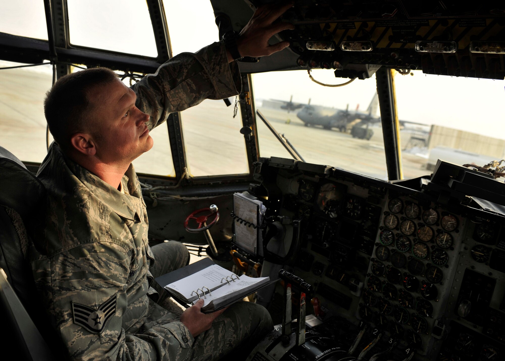 BAGRAM AIRFIELD, Afghanistan-- Staff Sgt. Aaron Wilson performs preflight maintenance on the flight deck of an EC-130 at Bagram Airfield, Afghanistan, Jan. 30, 2012. Wilson is a crew chief with the 41st Expeditionary Aircraft Maintenance Unit and is deployed from Davis-Monthan Air Force Base, Az.  (U.S. Air Force photo/ Airman 1st Class Ericka Engblom)