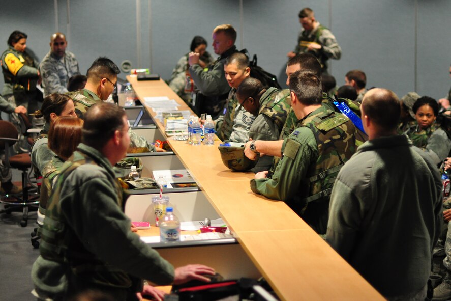 Different agency representatives from the 51st Fighter Wing process 25 individuals thorough a follow-on forces deployment line during Beverly Bulldog 12-01 at Osan Air Base Republic of Korea Jan. 30, 2012. Operational readiness exercises such as this are used to ensure members are ready and prepared to react to a wartime contingency and help defend South Korea.  (U.S. Air Force photo/Tech. Sgt. Chad Thompson)