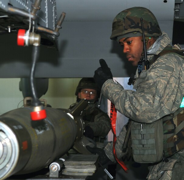 Staff Sgt. Jimmy Mills (right), instructs Senior Airman Douglas Howe to lift a GBU-12 to its designated point on an A-10 Thunderbolt II during an exercise at Osan Air Base Jan 30. Both Airmen are load crew members with the 25th Aircraft Maintenance Unit. Team Osan is participating in the first exercise of the year to test the base’s response during wartime operations. (U.S. Air Force photo/Staff Sgt. Stefanie Torres)