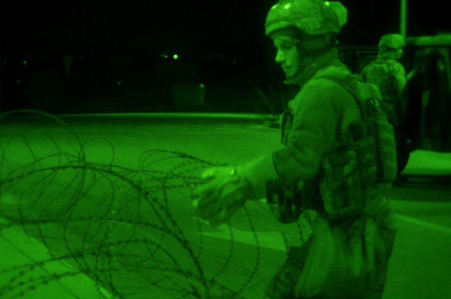 Airman 1st Class James Vanessen, 51st Security Forces Squadron, setup concertina wire around the base Jan. 30, 2012. The Airmen are participating in a peninsula-wide operational readiness exercise, Beverly Bulldog 12-01, held to train U.S. forces throughout South Korea. (U.S. Air Force photo/Staff Sgt. Craig R. Cisek)