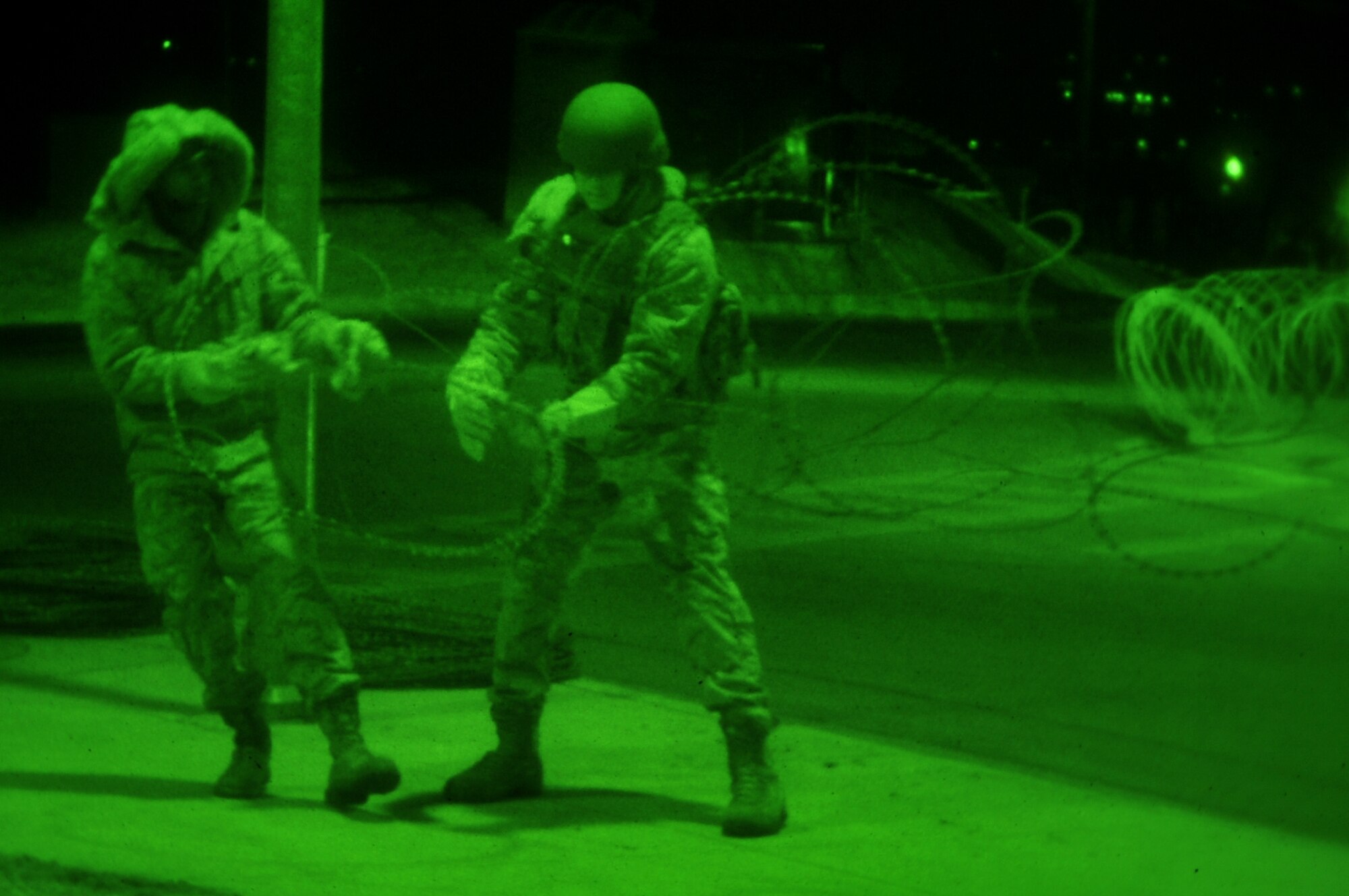 Airman 1st Class Eric Ottley and Staff Sgt. Aaron Kayo, 51st Security Forces Squadron, set up concertina wire around the base Jan. 30, 2012. The Airmen are participating in a peninsula-wide operational readiness exercise, Beverly Bulldog 12-01, held to train U.S. forces throughout South Korea. (U.S. Air Force photo/Staff Sgt. Craig R. Cisek)