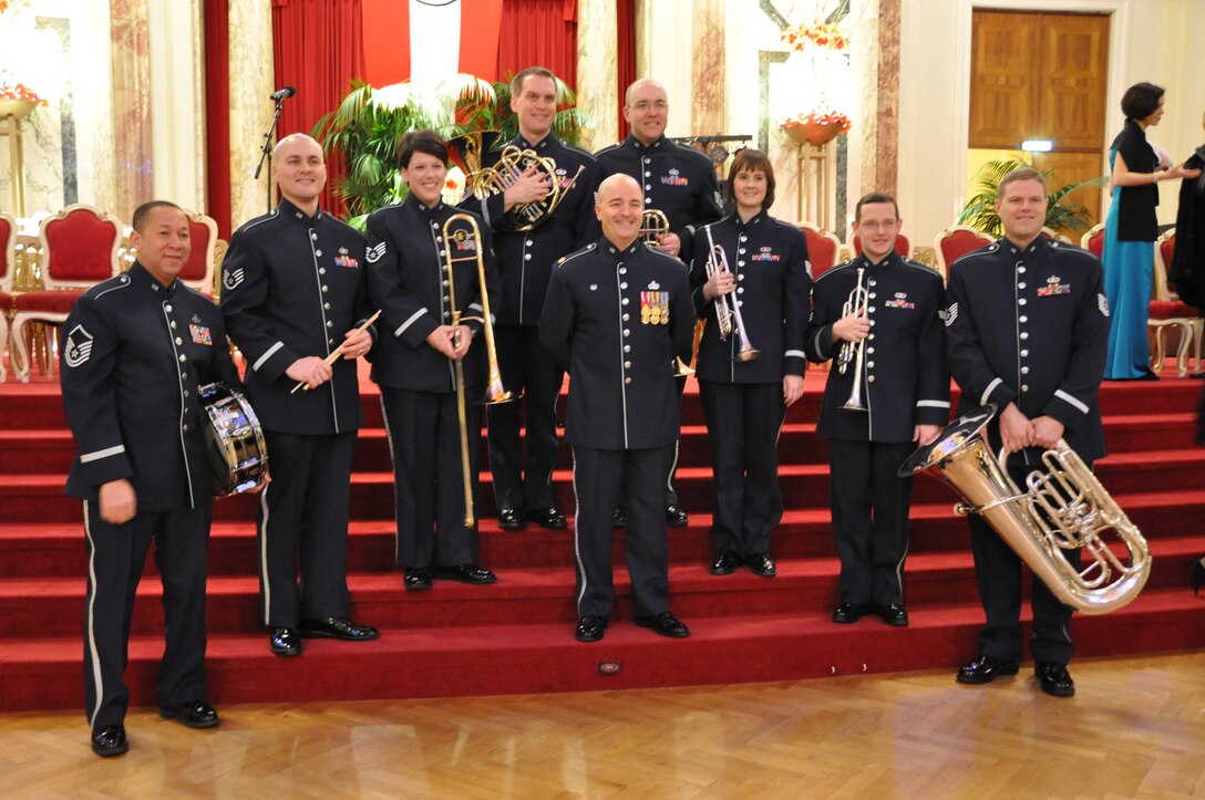 Members of the USAFE Band posing with Commander/Conductor Major Matthew Henry.