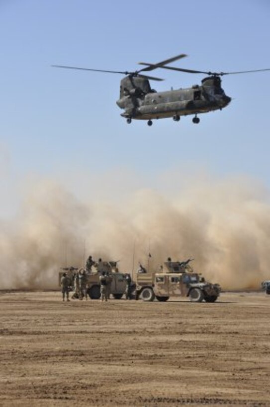 AFGHANISTAN — A Chinook helicopter bringing Regional Command West representatives to the Shindand Hospital ground breaking ceremony prepares to land, Jan. 28, 2012.