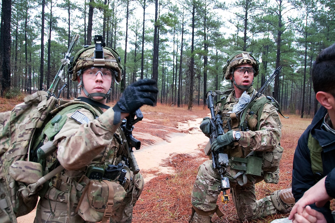 Army 1st Lt. Corey Miller, left, and Capt. Joseph Driskell coordinate an attack to capture a high-value individual in a simulated Afghan village at the Joint Readiness Training Center on Fort Polk, La., Jan. 26, 2012. Miller and Driskell are paratroopers assigned to the 82nd Airborne Division’s 1st Battalion, 504th Parachute Infantry Regiment, 1st Brigade Combat Team. 