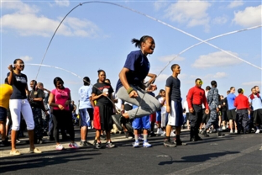 U.S. Navy Seaman Marcesia T. Mayes learns to double dutch during a "fun day" aboard the  aircraft carrier USS Carl Vinson in the Arabian Sea, Jan. 27, 2012. The Carl Vinson and Carrier Air Wing 17 are deployed to the U.S. 5th Fleet area of responsibility.