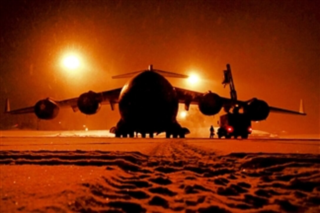 Air Force maintainers remove snow from a C-17 Globemaster III at Joint Base Elmendorf-Richardson, Alaska, on Jan. 12, 2012.  The airmen are assigned to the 703rd Aircraft Maintenance Squadron and the C-17 crew is assigned to the 3rd Air Wing.  
