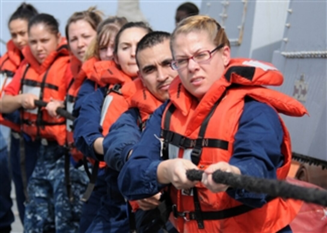U.S. Navy sailors assigned to the guided-missile destroyer USS Halsey (DDG 97) heave a line attached to a lifting band during a man overboard recovery drill in the Arabian Sea on Jan. 24, 2012.  The Halsey is on deployment to the western Pacific region.  