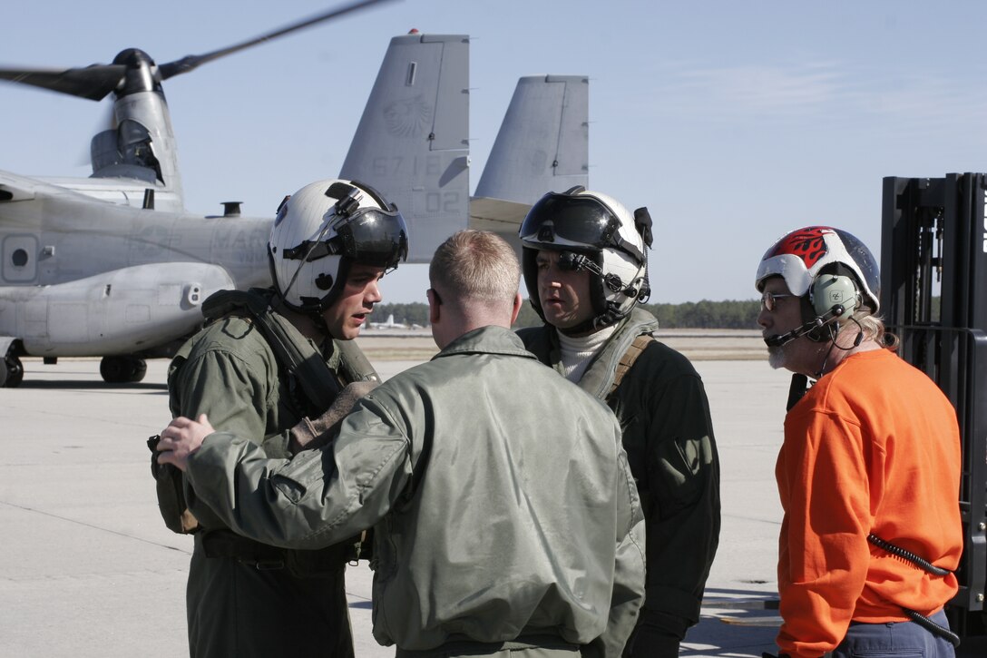 Capt. Douglas R. Kurz, supply and communications officer with Marine Attack Squadron 231, speaks with Sgt. Francis Rush and Sgt. David Meusy, crew chiefs with Marine Medium Tiltrotor Squadron 266, before loading supplies onto four MV-22 Ospreys on the Marine Corps Air Station Cherry Point flight line Jan. 31 in support of Bold Alligator 2012.  Kurz said the squadron’s contribution to Bold Alligator is helping with the supplies going onto and off the ships involved, and the squadron will also have some of its AV-8B Harriers in the exercise.