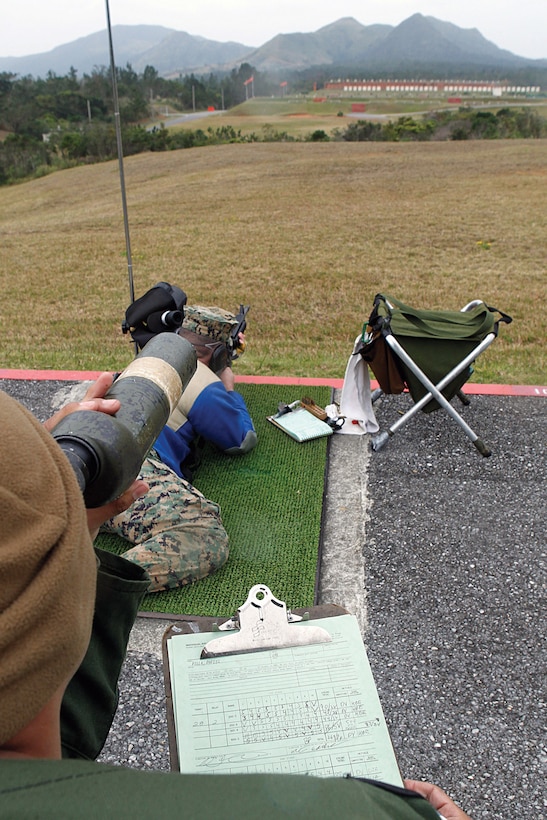 Marines from the Pacific region use telescopes to look for shot groups during the annual Far East Division Matches at Camp Hansen Jan. 31. During the marksmanship competition, shooters compete for individual medals as well as unit trophies.