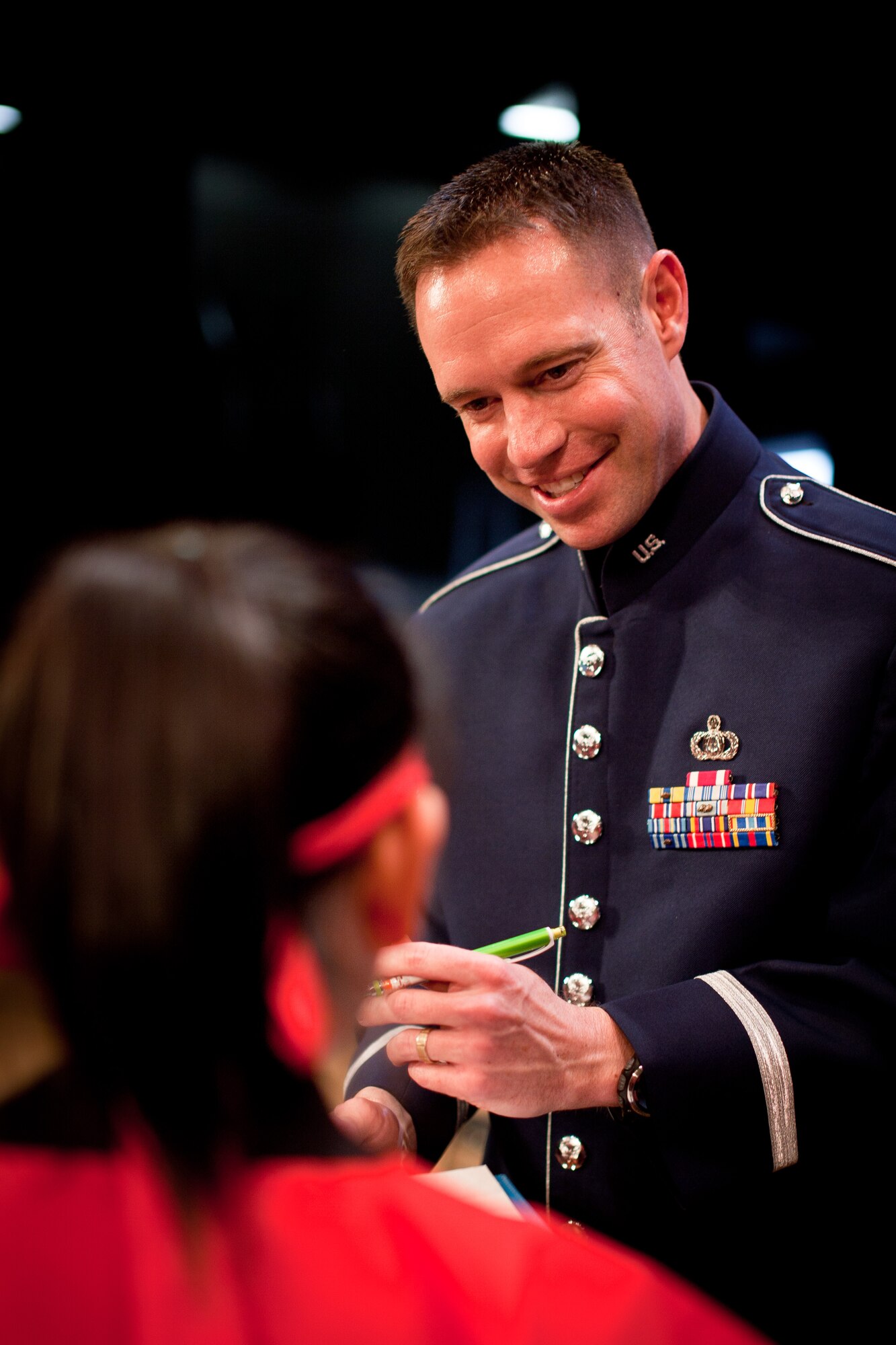 HAMURA CITY, Japan -- Master Sgt. Jeremy Laukhuf, Band of the Pacific Asia bassist, signs a autograph for a OZK24 member after the Japan-U.S. Joint Concert at the Yutorogi Learning Center, Hamura City, Japan, Jan. 28, 2012. Laukhuf made himself available for everyone that wanted a autograph or only to meet him. (U.S. Air Force photo/Staff Sgt. Josh Voyles)