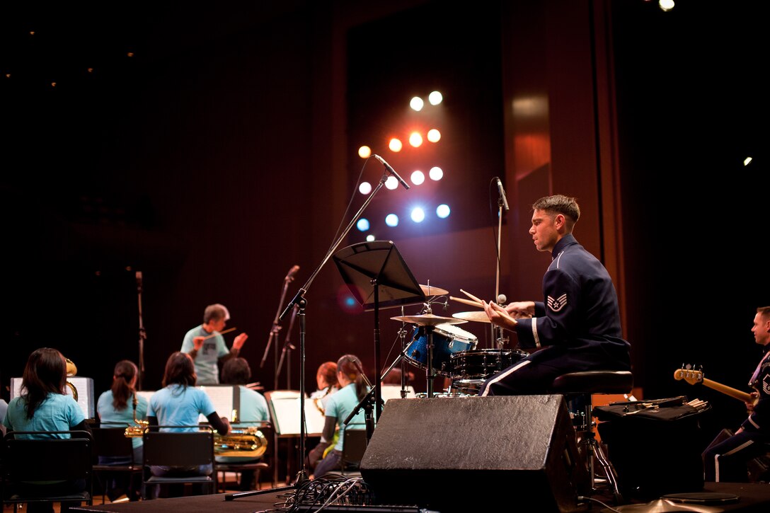 HAMURA CITY, Japan -- Staff Sgt. Steve Helfand, Band of the Pacific-Asia drummer, plays with the Hamura Wind Orchestra during the Japan-U.S. Joint Concert at the Yutorogi Learning Center, Hamura City, Japan, Jan. 28, 2012. Helfand, along with the two other members of Final Approach, performed with two music groups prior to performing as Final Approach. (U.S. Air Force photo/Staff Sgt. Josh Voyles)