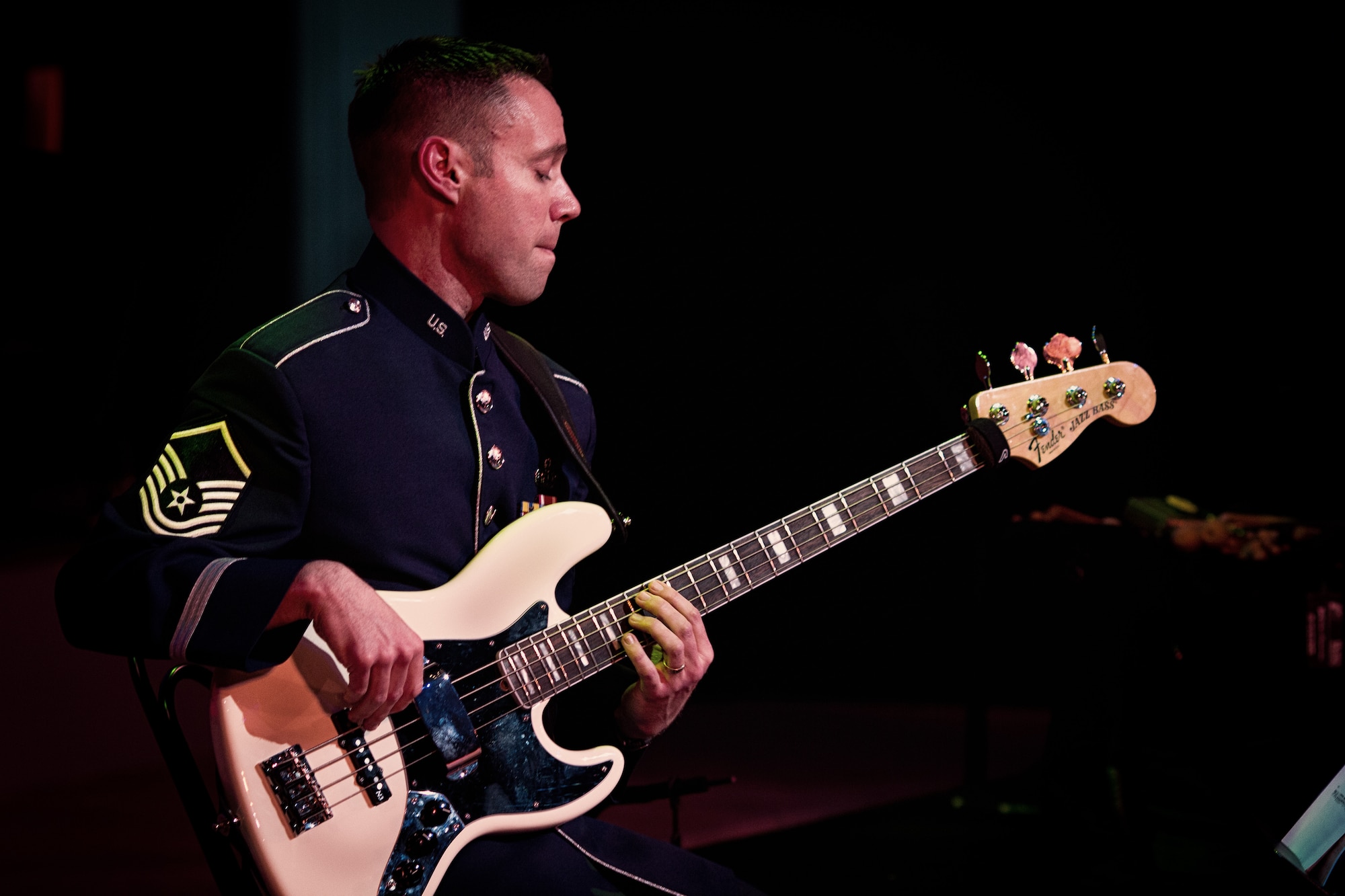 HAMURA CITY, Japan -- Master Sgt. Jeremy Laukhuf, Band of the Pacific-Asia bassist, frets the bass guitar's upper register during the Japan-U.S. Joint Concert at the Yutorogi Learning Center, Hamura City, Japan, Jan. 28, 2012. Laukhuf graced the entire guitar neck on every song he played. (U.S. Air Force photo/Staff Sgt. Josh Voyles)