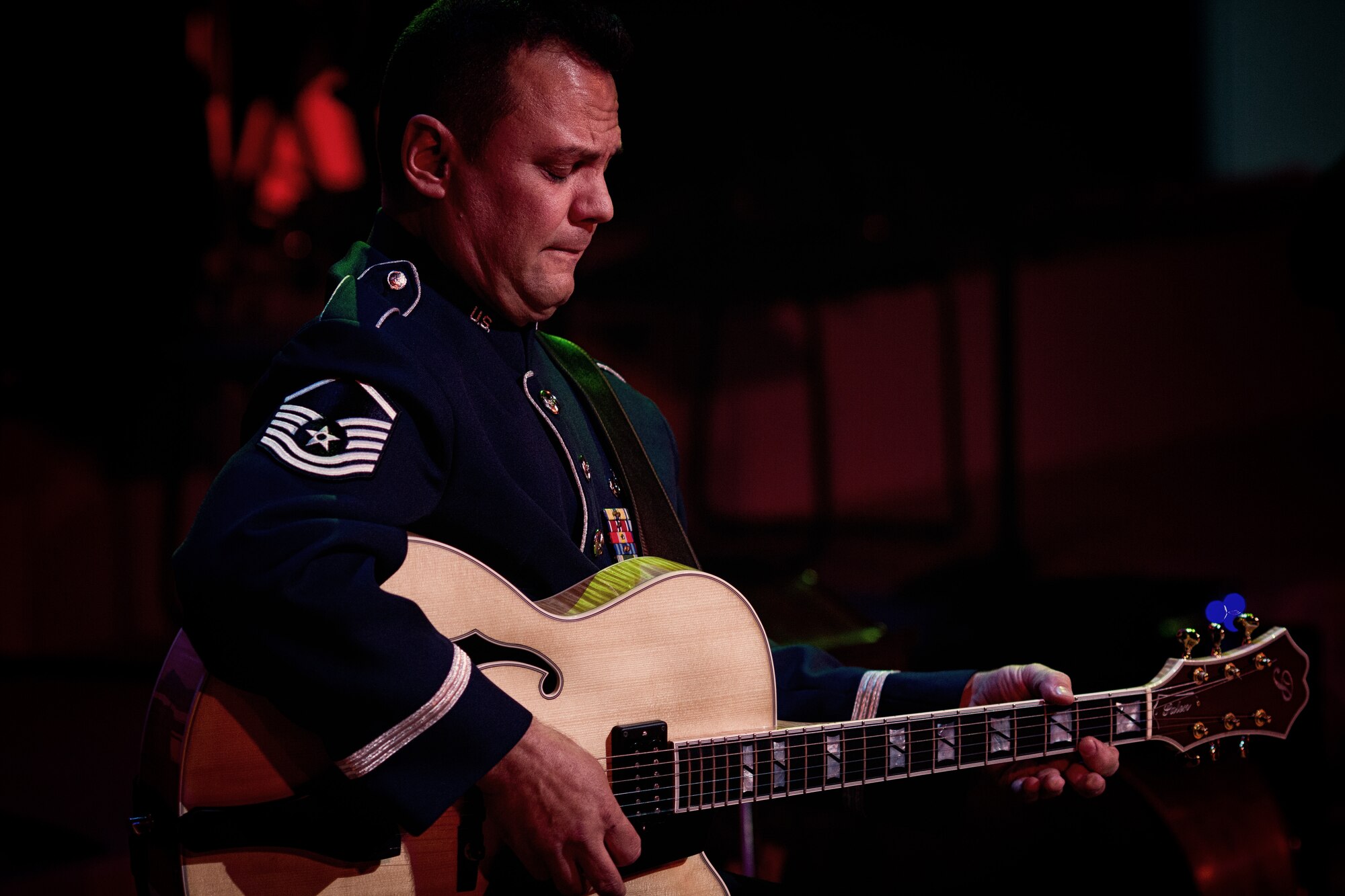 HAMURA CITY, Japan -- Master Sgt. Gary Rosenak, Band of the Pacific Asia guitarist, plays a solo on his "archtop" jazz guitar during the Japan-U.S. Joint Concert at the Yutorogi Learning Center, Hamura City, Japan, Jan. 28, 2012. Each musician performed a solo during the show, showcasing thier talent. (U.S. Air Force photo, Staff Sgt. Josh Voyles)