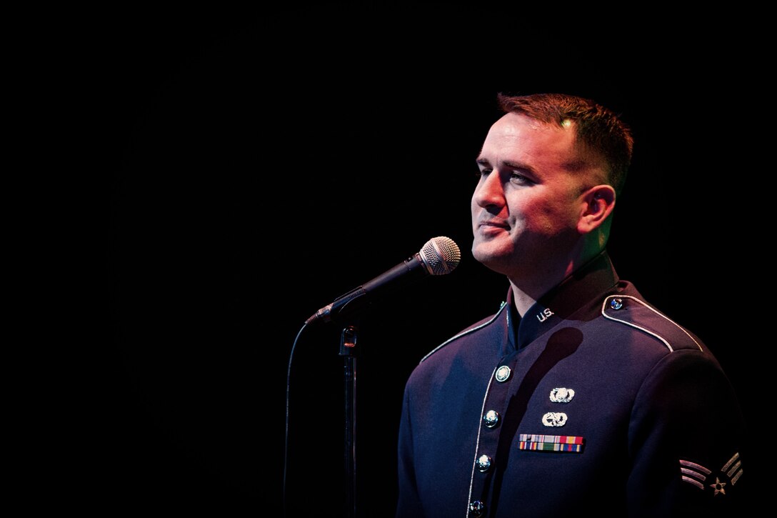 HAMURA CITY, Japan -- Senior Airman William Pressgrove, Band of the Pacific-Asia vocalist, pauses briefly during his performance of "Fly me to the moon" during the Japan-U.S. Joint Concert at the Yutorogi Learning Center, Hamura City, Japan, Jan. 28, 2012. Pressgrove typically performs with Pacific Trends, but sang as a guest on this performance. (U.S. Air Force photo/Staff Sgt. Voyles)